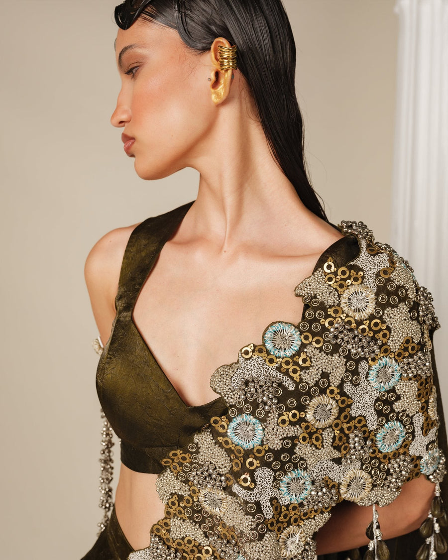 Close-up of an olive blouse with a hand-embroidered floral drape